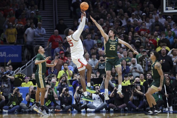 Maryland center Derik Queen, second from left, shoots the game-winning basket against Colorado State guard Ethan Morton (25) during the second half in the second round of the NCAA college basketball tournament, Sunday, March 23, 2025, in Seattle. (AP Photo/Ryan Sun)