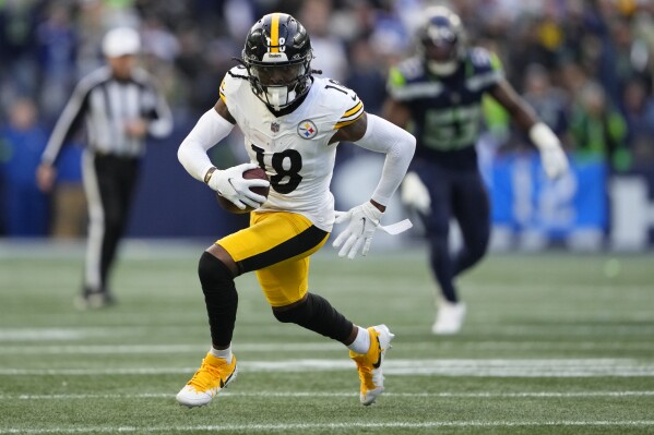 FILE -Pittsburgh Steelers wide receiver Diontae Johnson (18) runs the ball against the Seattle Seahawks during the second half of an NFL football game Sunday, Dec. 31, 2023, in Seattle. The Carolina Panthers gave quarterback Bryce Young the No. 1 wide receiver he's been lacking, acquiring Diontae Johnson from the Pittsburgh Steelers on Tuesday, March 12, 2024 for cornerback Donte Jackson. (AP Photo/Lindsey Wasson, File)