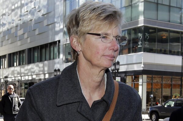 FILE - In this March 25, 2019, file photo, Donna Heinel, former University of Southern California athletics administrator, arrives at federal court in Boston to face charges in a nationwide college admissions bribery scandal. Heinel, who's charged with accepting bribes to get kids into USC, is among several fighting allegations in the case and will be going to trial in 2021. (AP Photo/Steven Senne, File)