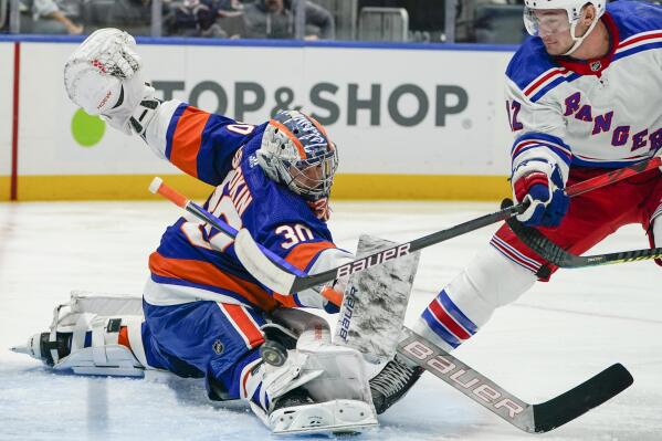 New York Islanders goaltender Ilya Sorokin (30) makes a save against New York Rangers' Julien Gauthier (12) in the first period of an NHL hockey game, Wednesday, Oct. 26, 2022, in Elmont, N.Y. (AP Photo/John Minchillo)