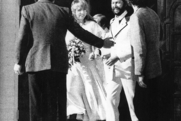 British rock star Eric Clapton and his bride, Pattie Boyd Harrison, leave a Tucson church after their marriage on Tuesday, March 27, 1979. Love letters to Pattie Boyd from both George Harrison and Eric Clapton are going up for sale at Christie鈥檚 auction house, alongside clothing, jewelry and other memorabilia from the renowned model and musicians鈥� muse. (AP Photo, File)