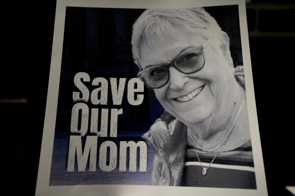A poster of Ada Sagi, 75-year-old mother of Noam Sagi, is on display at a press conference of British children of Israeli hostages at a hotel in London, Thursday, Oct. 12, 2023. Noam Sagi, 53, is a London-based psychotherapist who grew up on Kibbutz Nir Oz. His 75-year-old mother, Ada Sagi, was taken hostage on October 7. Sharon Lifschitz, 52, is an artist and academic whose parents are peace activists aged 85 and 83 and were taken hostage too. (AP Photo/Kirsty Wigglesworth)