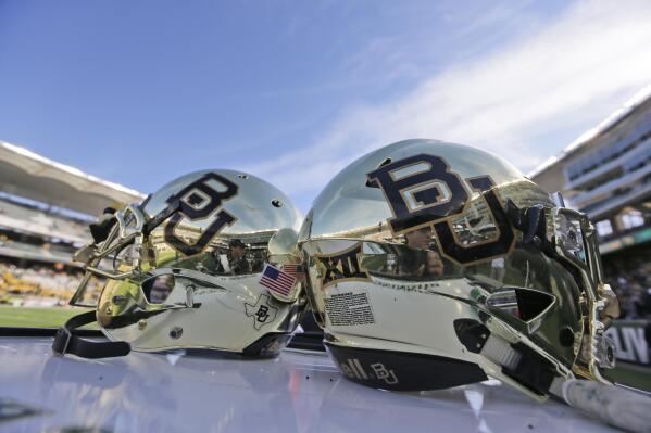 FILE - In this Dec. 5, 2015, file photo, Baylor helmets on shown the field after an NCAA college football game in Waco, Texas. The NCAA infractions committee said Wednesday, Aug. 11, 2021, that its years-long investigation into the Baylor sexual assault scandal would result in four years probation and other sanctions, though the “unacceptable” behavior at the heart of the case did not violate NCAA rules.(AP Photo/LM Otero, File)