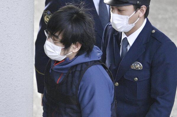 Tetsuya Yamagami, the alleged assassin of Japan's former Prime Minister Shinzo Abe, enters a police station in Nara, western Japan, on Jan. 10, 2023. Japanese prosecutors formally charged the suspect in the assassination of former Prime Minister Shinzo Abe with murder, Japan's NHK public television reported Friday, Jan. 13, 2023. (Kyodo News via AP)