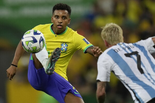 Brazil's Rodrygo controls the ball challenged by Argentina's Rodrigo De Paul during a qualifying soccer match for the FIFA World Cup 2026 at Maracana stadium in Rio de Janeiro, Brazil, Tuesday, Nov. 21, 2023. (AP Photo/Silvia Izquierdo)