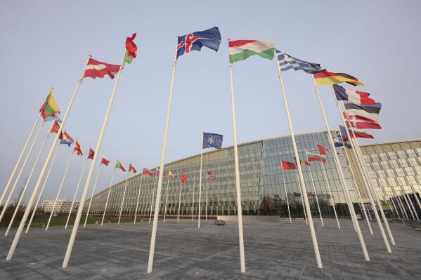 Flags of NATO members fly outside the NATO headquarters ahead of NATO Secretary General Jens Stoltenberg, European Commission President Ursula von der Leyen and European Council President Charles Michel signing a joint declaration on NATO-EU Cooperation at NATO headquarters in Brussels, Tuesday, Jan. 10, 2023. (AP Photo/Olivier Matthys)