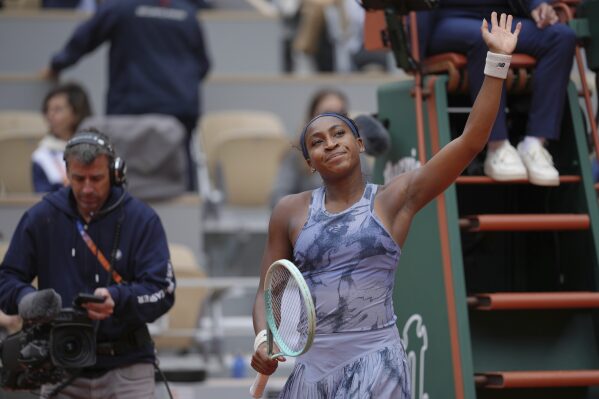 Coco Gauff of the U.S. waves to fans after defeating Australia's Olivia Gadecki during their first round match of the French Tennis Open, at the Roland-Garros stadium, in Paris, Tuesday, May 27, 2025. (AP Photo/Thibault Camus)
