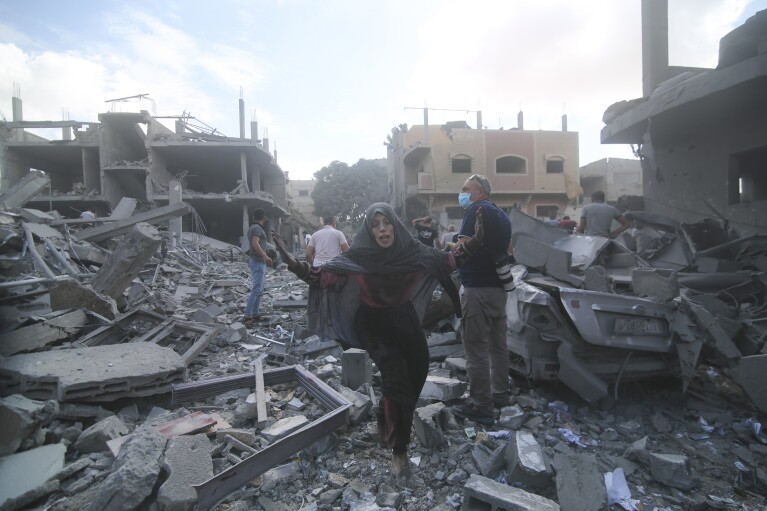 Palestinians flee Israeli bombardment of Rafah, southern Gaza Strip, Tuesday, Oct. 17, 2023. (AP Photo/Hatem Ali)