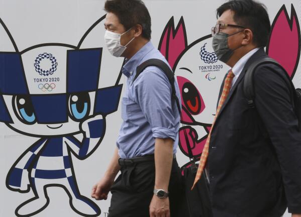 People walk by posters to promote the Olympic Games planned to start in the summer of 2021, in Tokyo, Wednesday, June 16, 2021. (AP Photo/Koji Sasahara)