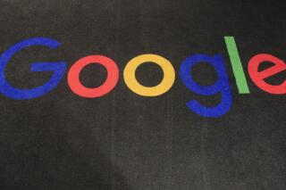 FILE - In this Nov. 18, 2019 file photo, the logo of Google is displayed on a carpet at the entrance hall of Google France in Paris. A new search feature rolled out Wednesday, Oct. 6, 2021 tells users which flights have lower carbon emissions, giving them the ability to choose flights based on carbon emissions just as they would price or the number of layovers. (AP Photo/Michel Euler, File)