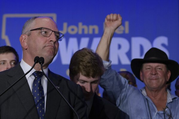Louisiana Gov. John Bel Edwards arrives to address supporters at his election night watch party in Baton Rouge, La., Saturday, Nov. 16, 2019. (AP Photo/Matthew Hinton)