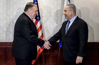 US Secretary of State Mike Pompeo and Israeli Prime Minister Benjamin Netanyahu shake hands during their meeting in Lisbon Wednesday, Dec. 4, 2019. (AP Photo/Patricia De Melo Moreira, Pool)