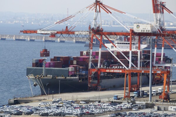 FILE - A container ship is loaded and unloaded at a container terminal at a port of Kawasaki near Tokyo on March 9, 2022. Japan’s exports fell 0.8% in August 2023 from a year earlier, with steep declines in shipments to China and the rest of Asia, its largest regional market. (AP Photo/Koji Sasahara, File)