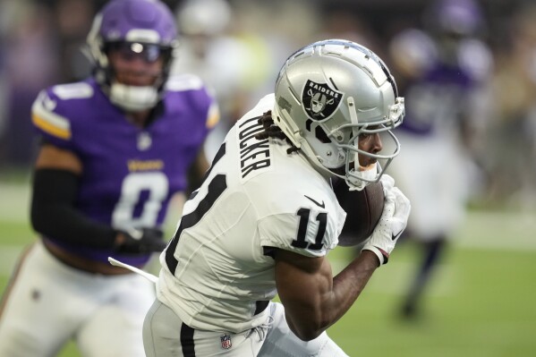 Las Vegas Raiders wide receiver Tre Tucker (11) makes a catch in front of Minnesota Vikings linebacker Ivan Pace Jr. (0) during the first half of an NFL football game Saturday, Aug. 10, 2024, in Minneapolis. (AP Photo/Charlie Neibergall)