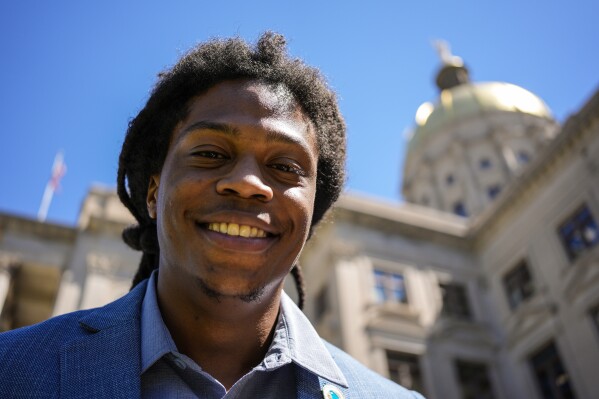 Davante Jennings poses for a photo at the state Capitol, Thursday, March 28, 2024, in Atlanta. Not long ago, Jennings was not even an active voter. He had given up on politics after the 2016 presidential election — his first time voting. But he was targeted by the New Georgia Project ahead of the 2022 elections and now helps reach out to would-be voters. (AP Photo/Mike Stewart)