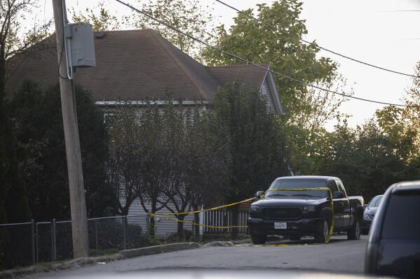 Police tape blocks off access to a fatal shooting at a house early Sunday, Oct. 31, 2021 in Joliet, Ill.  Police were seeking tips from the public in finding two suspected shooters who fled from the scene and were also seeking witnesses or anyone who may have video or photographs from the party. (Anthony Vazquez /Chicago Sun-Times via AP)