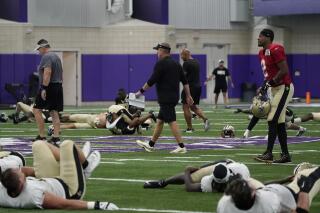 New Orleans Saints head coach Sean Payton, center, walks past quarterback Jameis Winston (2) and others as they stretch before the start of NFL football practice at TCU in Fort Worth, Texas, Wednesday, Sept. 22, 2021. (AP Photo/Tony Gutierrez)