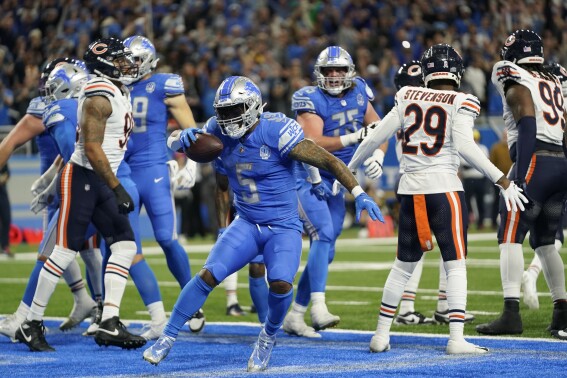 Detroit Lions running back David Montgomery (5) runs in the endzone after his 1-yard rushing touchdown during the second half of an NFL football game against the Chicago Bears, Sunday, Nov. 19, 2023, in Detroit. (AP Photo/Paul Sancya)
