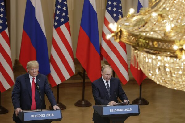
              U.S. President Donald Trump, left, listens to Russian President Vladimir Putin during a press conference after their meeting at the Presidential Palace in Helsinki, Finland, Monday, July 16, 2018. (AP Photo/Markus Schreiber)
            