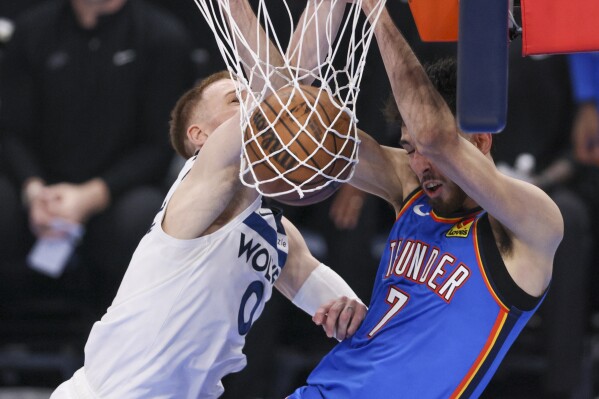 Oklahoma City Thunder forward Chet Holmgren (7) dunks on Minnesota Timberwolves guard Donte DiVincenzo (0) during the second half of Game 2 of an NBA basketball Western Conference Finals playoff series Thursday, May 22, 2025, in Oklahoma City. (AP Photo/Nate Billings)
