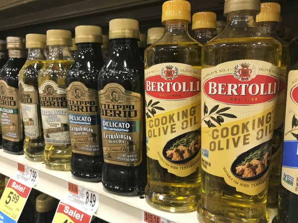 A variety of olive oils are displayed at a grocery store in Waterbury, Vt. on March 26, 2021. There is a lot of confusion about which olives oils to buy and how to use them. For most of us, the world of olive oil is a bit of a mystery, and you may find yourself with an uncertainty similar to the one you feel in a wine store when you are contemplating the plethora of bottles lined up for the choosing. (AP Photo/Carolyn Lessard)