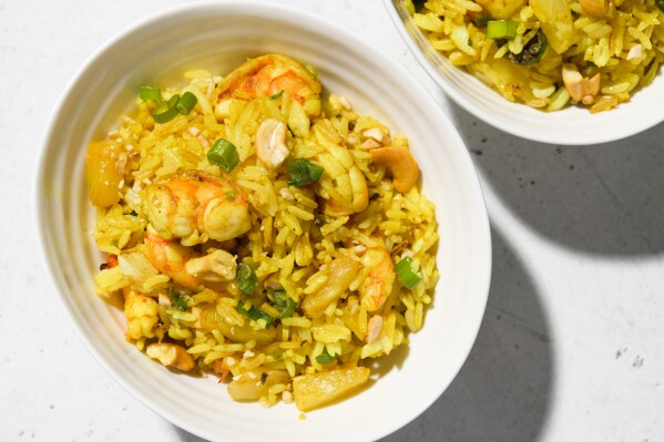 This image released by Milk Street shows a recipe for curried fried rice with shrimp and pineapple. (Milk Street via AP)