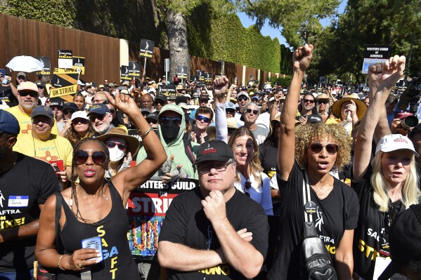 Sean Astin, center, Michelle Hurd, second right, and marchers attend the Day of Solidarity union rally on Tuesday, Aug. 22, 2023, at Disney Studios in Burbank, Calif. The event includes members of SAG-AFTRA, the WGA and the AFL-CIO. (Photo by Jordan Strauss/Invision/AP)