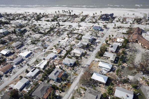 FILE - This aerial photo shows damaged homes and debris in the aftermath of Hurricane Ian, Sept. 29, 2022, in Fort Myers Beach, Fla. (AP Photo/Wilfredo Lee, File)