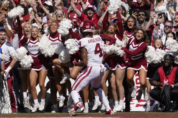 Oklahoma wide receiver Nic Anderson (4) scores the game winning touchdown late in the second half of an NCAA college football game against Texas at the Cotton Bowl in Dallas, Saturday, Oct. 7, 2023. (AP Photo/LM Otero)