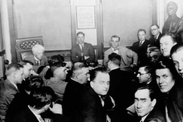 This 1921 file photo shows Judge Kenesaw Mountain Landis, rear left, as Chicago White Sox players, Charles "Swede" Risberg, center left, and Arnold "Chick" Gandil, look on during the investigation of the infamous "Black Sox" scandal in Chicago. (AP Photo/File)