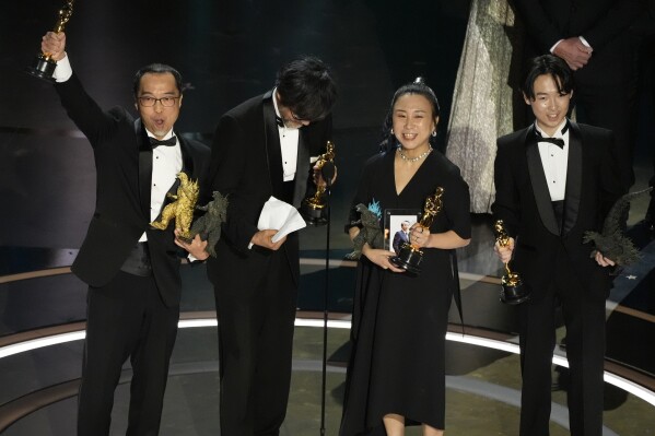Masaki Takahashi, from left, Takashi Yamazaki, Kiyoko Shibuya, and Tatsuji Nojima accept the award for best visual effects for "Godzilla Minus One" during the Oscars on Sunday, March 10, 2024, at the Dolby Theatre in Los Angeles. (AP Photo/Chris Pizzello)
