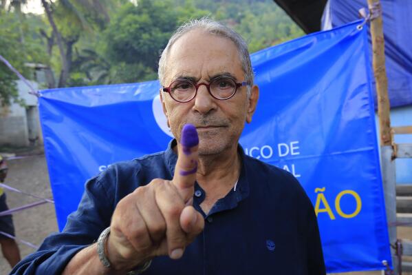 FILE - East Timorese presidential candidate who is also former President Jose Ramos-Horta shows his inked finger after casting his ballot at a polling station during the election in Dili, East Timor on March 19, 2022. Voters in East Timor are choosing a president in a runoff Tuesday, April 19, 2022 between former independence fighters who’ve blamed each other for years of political paralysis. (AP Photo/Lorenio Do Rosario Pereira, File)