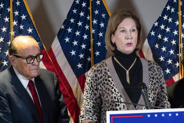 FILE - Sidney Powell, right, speaks next to former Mayor of New York Rudy Giuliani, as members of President Donald Trump's legal team, during a news conference at the Republican National Committee headquarters on Nov. 19, 2020, in Washington. Powell has pleaded guilty to reduced charges over efforts to overturn Donald Trump’s loss in the 2020 election in Georgia. Powell is the second defendant in the sprawling case to reach a deal with prosecutors. (AP Photo/Jacquelyn Martin, File)