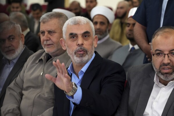 FILE - Yahya Sinwar, head of Hamas in Gaza, greets his supporters upon his arrival at a meeting in a hall on the sea side of Gaza City, on April 30, 2022. Since Hamas fighters carried out the deadliest attack on Israel in decades, Israeli officials have vowed to crush the Palestinian militant group and its enigmatic leader in Gaza, Yahya Sinwar. But seven weeks into the war, 61-year-old Sinwar remains alive, in hiding and at the helm of Hamas’ fighters as they battle Israeli forces. (AP Photo/Adel Hana, File)