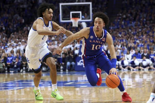Kansas' Jalen Wilson (10) drives against Kentucky's Jacob Toppin during the second half of an NCAA college basketball game in Lexington, Ky., Saturday, Jan. 28, 2023. Kansas won 77-68. (AP Photo/James Crisp)