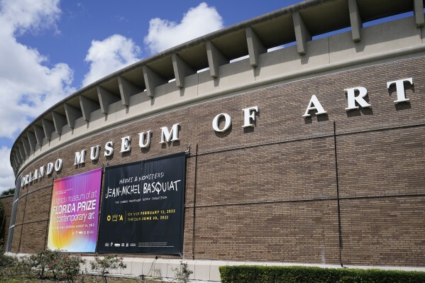 A banner advertising an exhibit by artist Jean-Michel Basquiat hangs from the exterior of the Orlando Museum of Art, where a collection of Basquiat's paintings were on display, June 2, 2022, in Orlando, Florida. (AP Photo/John Raoux, File)