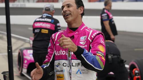 Helio Castroneves, of Brazil, talks with his crew during qualifications for the IndyCar Grand Prix auto race at Indianapolis Motor Speedway, Friday, May 12, 2023, in Indianapolis. (AP Photo/Darron Cummings)
