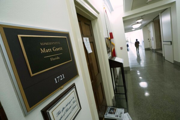 People pass by the Rep. Matt Gaetz, R-Fla., office on Capitol Hill, in Washington, Tuesday, April 13, 2021. The House Ethics Committee has opened an investigation of Rep. Gaetz, citing reports of sexual and other misconduct by the Florida Republican. (AP Photo/Jose Luis Magana)