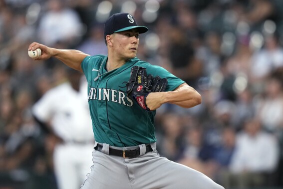 Seattle Mariners starting pitcher Bryan Woo delivers during the first inning of the team's baseball game against the Chicago White Sox on Tuesday, Aug. 22, 2023, in Chicago. (AP Photo/Charles Rex Arbogast)