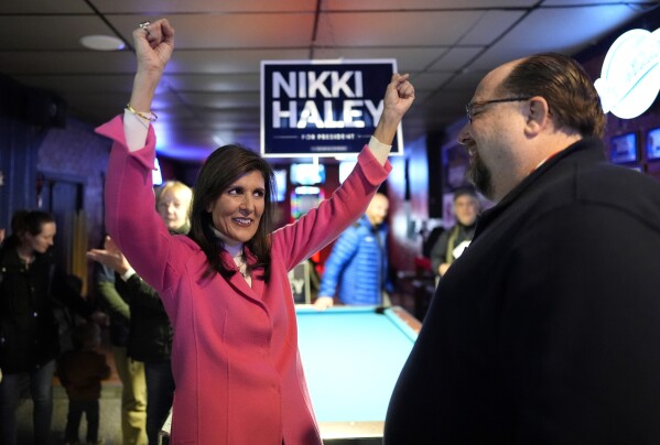 Republican presidential candidate Nikki Haley, left, reacts as she speaks with attendee Chris Varney during a campaign event in Newton, Iowa on Monday. (AP Photo/Carolyn Kaster)