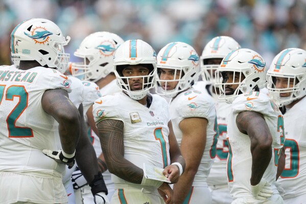 Miami Dolphins quarterback Tua Tagovailoa (1) listens to offensive tackle Terron Armstead (72) during the second half of an NFL football game against the Las Vegas Raiders, Sunday, Nov. 19, 2023, in Miami Gardens, Fla. (AP Photo/Rebecca Blackwell)