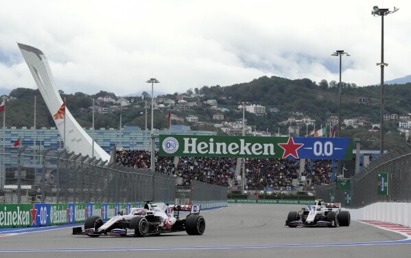FILE - Haas driver Nikita Mazepin of Russia, left, and Haas driver Mick Schumacher of Germany compete at the Russian Formula One Grand Prix in Sochi, Russia, Sunday, Sept. 26, 2021. Sochi, which hosted the 2014 Winter Olympics, later served as a venue for other international sporting events, including Formula One racing, until the event was pulled from Russia in response to the conflict in Ukraine. (AP Photo/Sergei Grits, File)