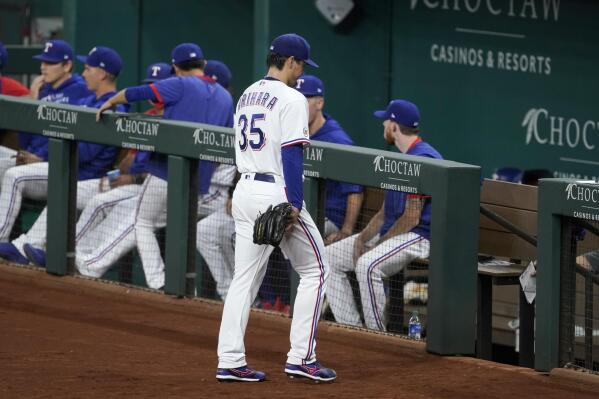 Texas Rangers starting pitcher Kohei Arihara (35) leaves the field after turning the ball over in the fifth inning of a baseball game against the Houston Astros in Arlington, Texas, Wednesday, Sept. 15, 2021. (AP Photo/Tony Gutierrez)