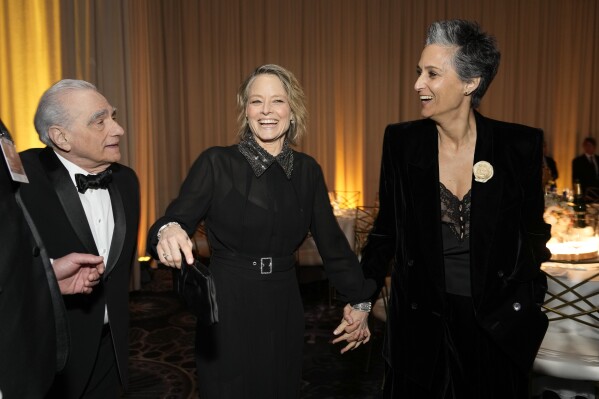 Martin Scorsese, from left, Jodie Foster, and Alexandra Hedison arrive at the 81st Golden Globe Awards at the Beverly Hilton in Beverly Hills, California on Sunday, January 7, 2024.  (AP Photo/Chris Pizzello)