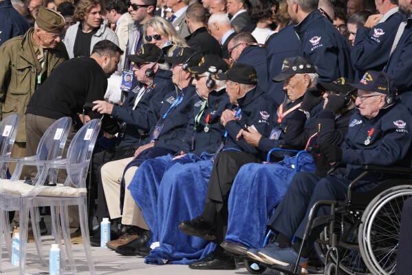 Ukraine's President Volodymyr Zelenskyy, second left, greets World War II veterans at the international ceremony at Omaha Beach, Thursday, June 6, 2024, in Normandy, France. Normandy is hosting various events to officially commemorate the 80th anniversary of the D-Day landings that took place on June 6, 1944. (AP Photo/Virginia Mayo, Pool)