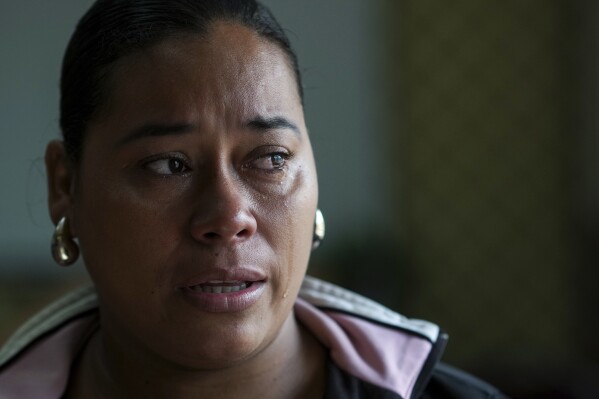 Larissa Martinez, who was deported from the U.S. in 2021 with her three children, reacts during an interview in San Pedro Sula, Honduras, Wednesday, Dec. 4, 2024. (AP Photo/Moises Castillo)