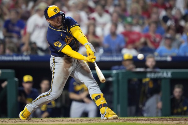Milwaukee Brewers' William Contreras hits a run-scoring double against Philadelphia Phillies pitcher Andrew Bellatti during the ninth inning of a baseball game, Wednesday, July 19, 2023, in Philadelphia. (AP Photo/Matt Slocum)