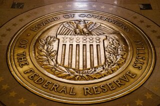 FILE - In this Feb. 5, 2018, file photo, the seal of the Board of Governors of the U.S, Federal Reserve System lies embedded in the floor at the Marriner S. Eccles Federal Reserve Board Building in Washington. The Federal Reserve announced late Wednesday, March 18, 2020, that it will establish an emergency lending facility to help unclog a short-term credit market that has been disrupted by the coronavirus outbreak. The Fed said it will lend money to banks that purchase financial assets from money market mutual funds, including short-term IOUs known as commercial paper. (AP Photo/Andrew Harnik, File)