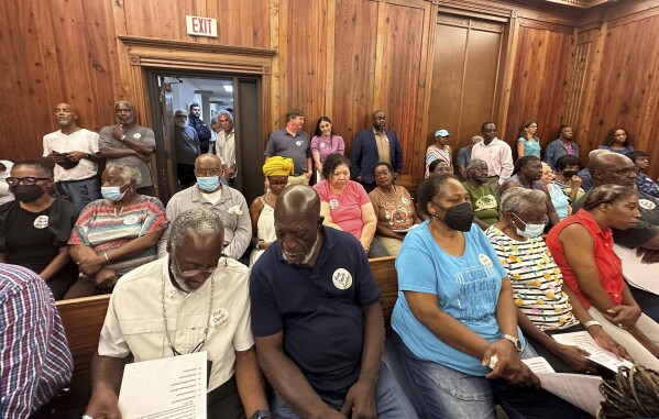 Residents, landowners and supporters of the Hogg Hummock community on Sapelo Island fill a courtroom in Darien, Ga., on Tuesday, Sept. 12, 2023, as McIntosh County commissioners meet to approve zoning changes that some fear will endanger the Gullah-Geechee enclave founded by formerly enslaved people. Commissioners voted to double the size of homes allowed in the tiny community, raising concerns that rising property values and tax increases will force out the indigenous population. (AP Photo/Russ Bynum)