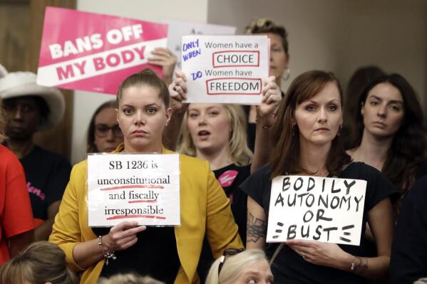 FILE - In this Aug. 12, 2019, file photo, people wait for a Senate hearing to begin to discuss a fetal heartbeat abortion ban, or possibly something more restrictive in Nashville, Tenn. The assertion by proponents that abortion as early as six weeks into pregnancy “stops a beating heart” was arguably the stroke of political genius that helped so-called “heartbeat bills” defy constitutional concerns to become law in 12 states. None has taken effect due to court challenges, the latest being argued Thursday, April 29, 2021, in Tennessee. (AP Photo/Mark Humphrey, File)